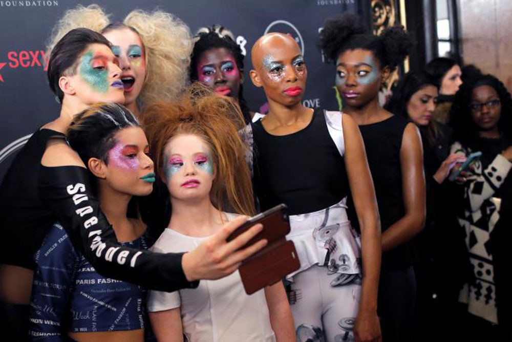 The young designer poses with her models backstage (photo c/o AFP)